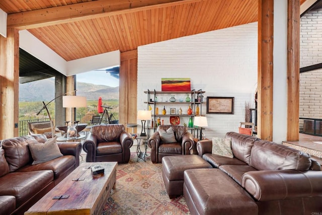 living room with a mountain view, wood ceiling, lofted ceiling with beams, and brick wall