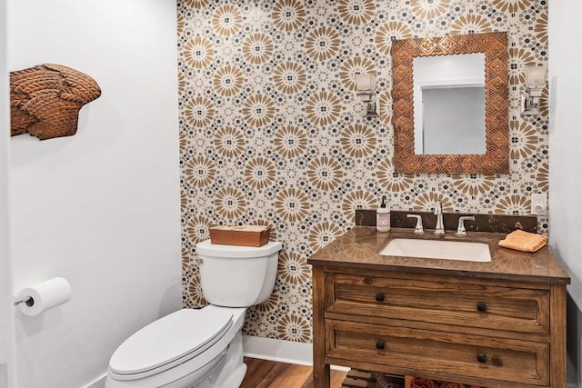 bathroom featuring vanity, toilet, and wood-type flooring