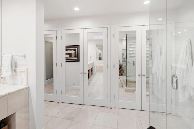 bathroom featuring french doors, vanity, an enclosed shower, and tile patterned flooring