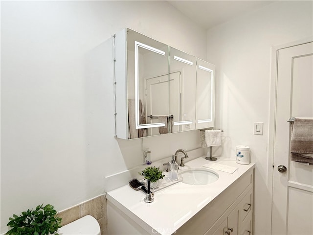 bathroom featuring vanity and toilet