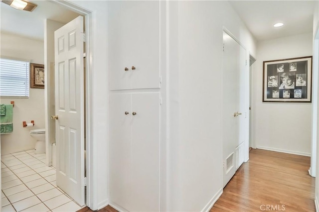 hall featuring light tile patterned floors