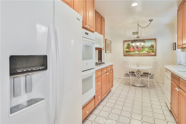 kitchen with white appliances and decorative light fixtures