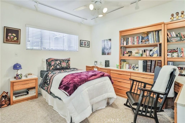 carpeted bedroom featuring ceiling fan and rail lighting