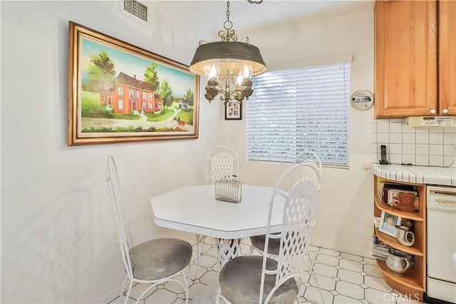 dining space with a chandelier