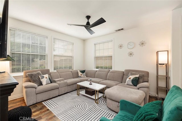 living room featuring ceiling fan and hardwood / wood-style floors