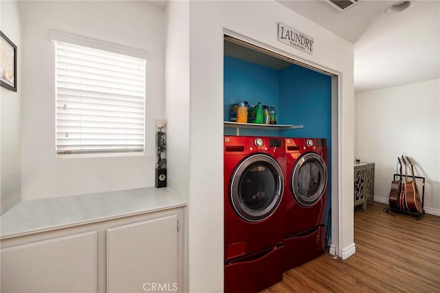 laundry room with hardwood / wood-style flooring and separate washer and dryer