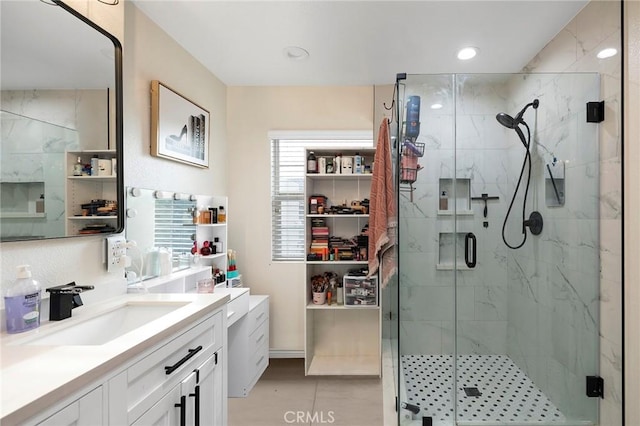 bathroom featuring vanity, an enclosed shower, and tile patterned flooring