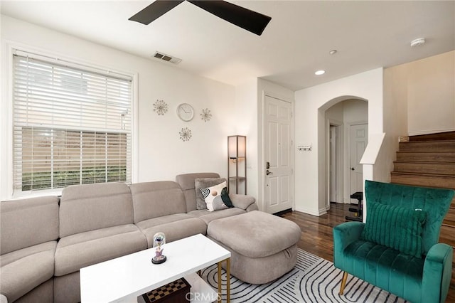 living room with dark wood-type flooring and ceiling fan