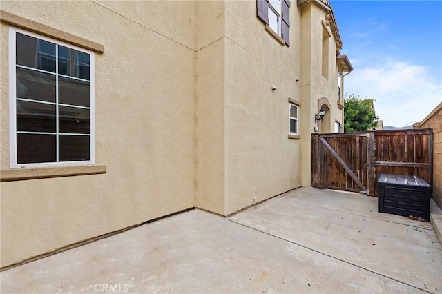 view of side of home with a patio area