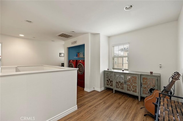 interior space with hardwood / wood-style flooring and washer and clothes dryer