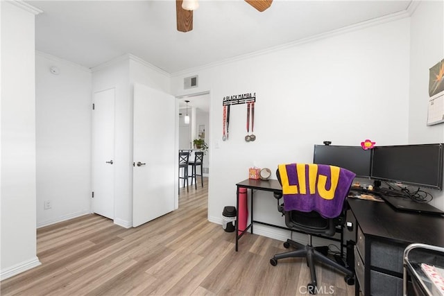 office space with ornamental molding, ceiling fan, and light wood-type flooring