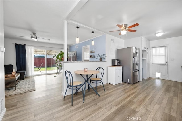 dining room with crown molding, light hardwood / wood-style flooring, and ceiling fan