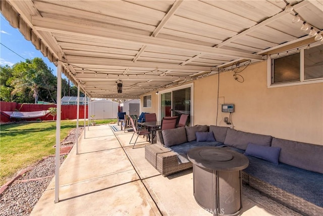 view of patio / terrace with an outdoor hangout area and a storage unit