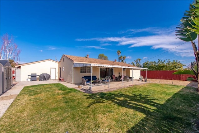 back of property featuring a patio and a lawn