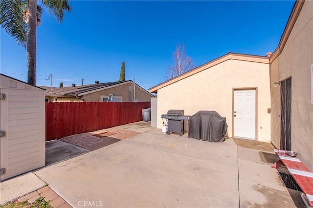 view of patio / terrace with grilling area and a storage unit