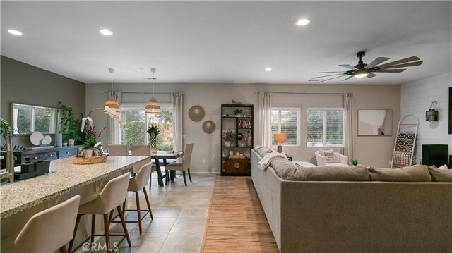 living room featuring ceiling fan, a healthy amount of sunlight, and light hardwood / wood-style floors