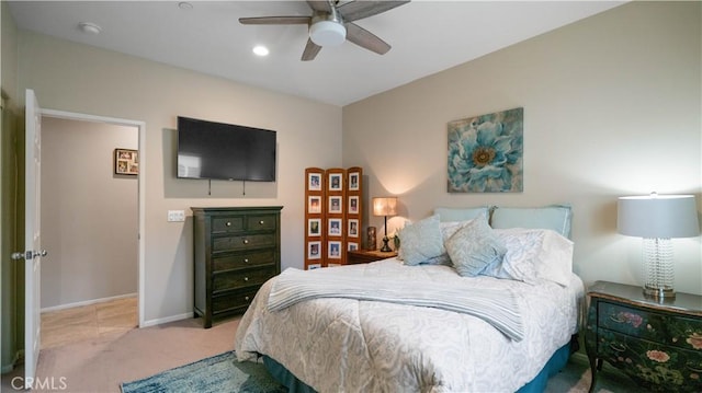 bedroom featuring light colored carpet and ceiling fan