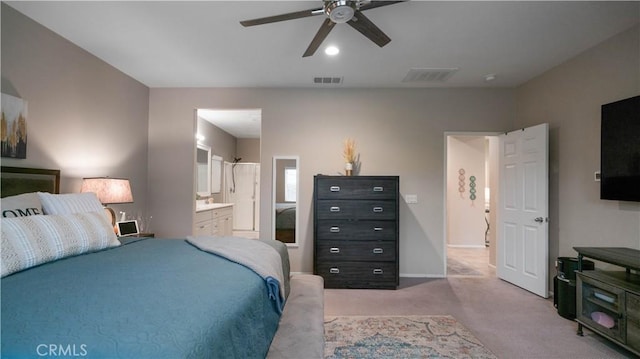 bedroom featuring light carpet, connected bathroom, and ceiling fan