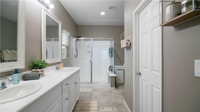 bathroom featuring an enclosed shower and vanity