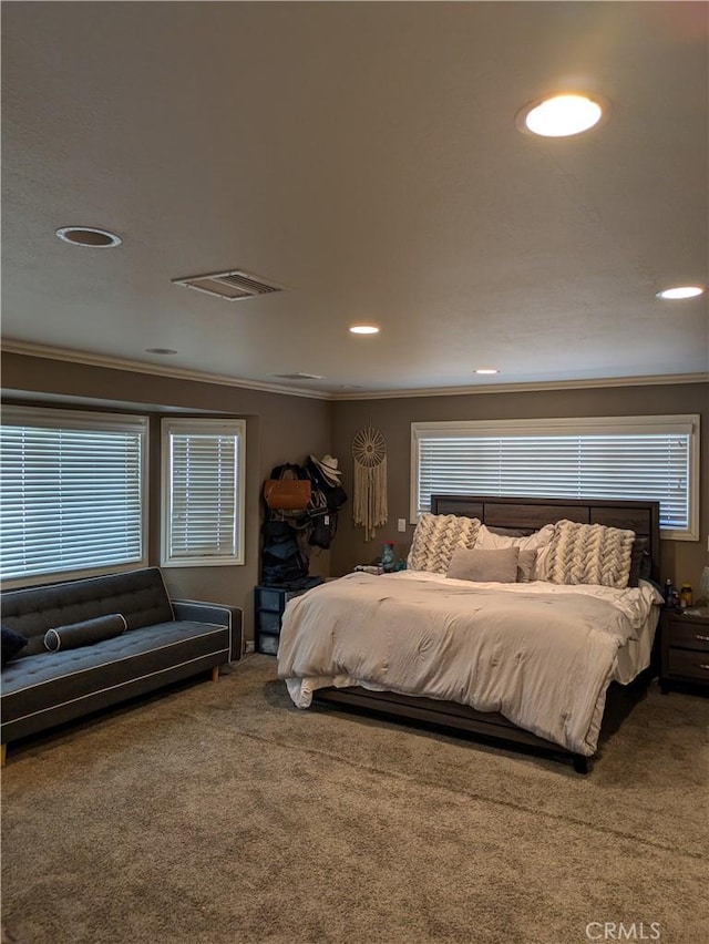 bedroom with multiple windows, ornamental molding, and carpet