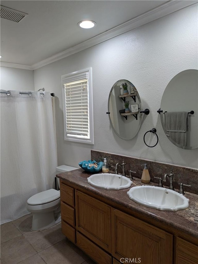 bathroom featuring vanity, tile patterned flooring, ornamental molding, and toilet