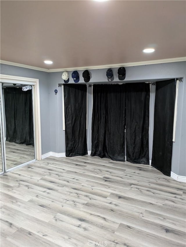 interior space featuring crown molding and light hardwood / wood-style floors