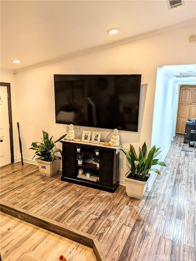 living room featuring crown molding and hardwood / wood-style floors