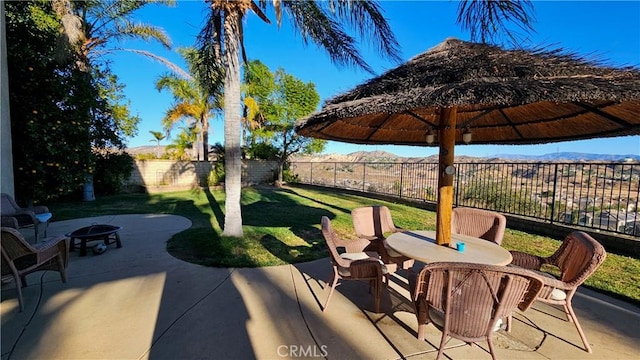 view of patio / terrace with a mountain view and an outdoor fire pit