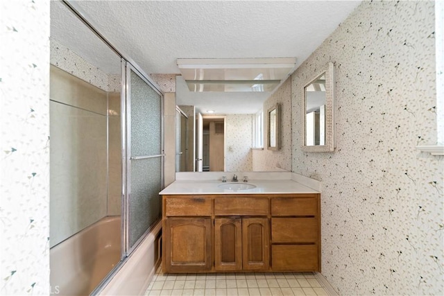 bathroom with enclosed tub / shower combo, vanity, tile patterned flooring, and a textured ceiling