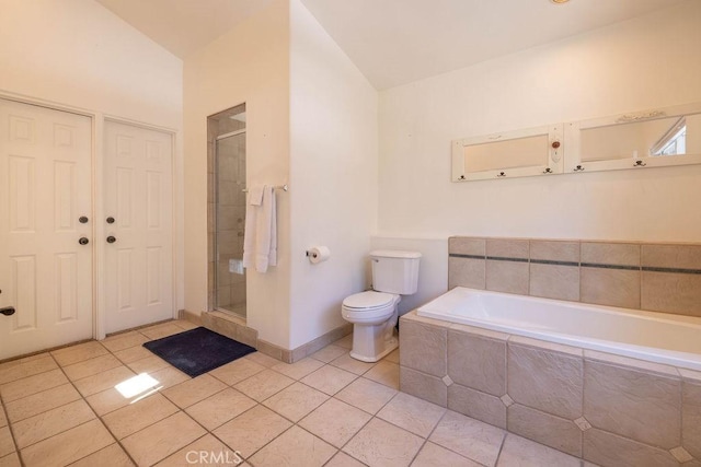 bathroom with tile patterned floors, toilet, and separate shower and tub