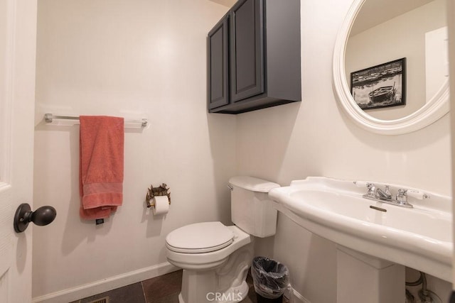 bathroom featuring toilet and tile patterned flooring