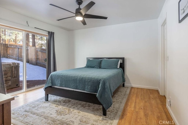 bedroom featuring access to exterior, light hardwood / wood-style flooring, and ceiling fan