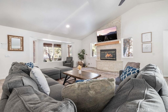 living room with a fireplace and high vaulted ceiling