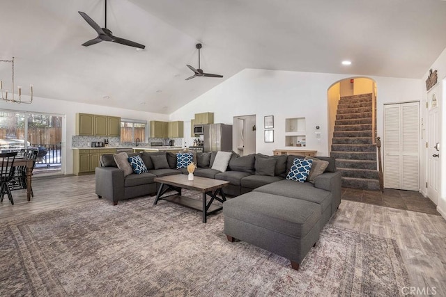 living room with ceiling fan, high vaulted ceiling, and hardwood / wood-style floors