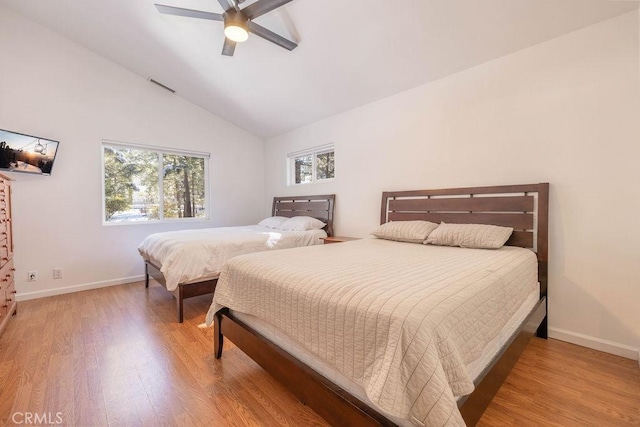 bedroom featuring wood-type flooring, vaulted ceiling, and ceiling fan