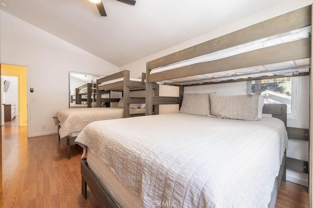 bedroom with hardwood / wood-style flooring, vaulted ceiling, and ceiling fan