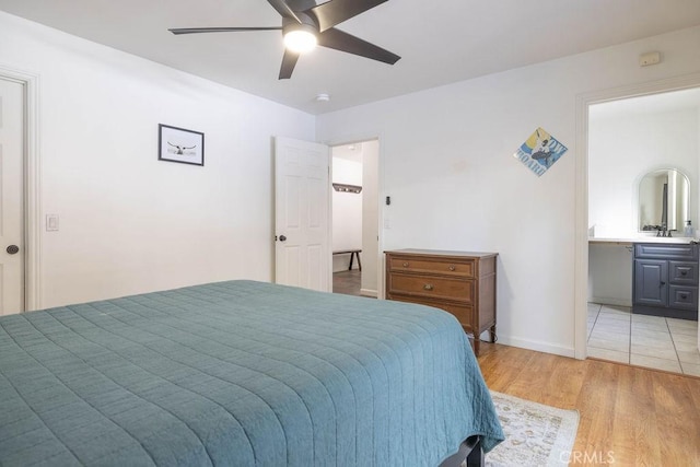 bedroom with ensuite bath, light hardwood / wood-style floors, and ceiling fan