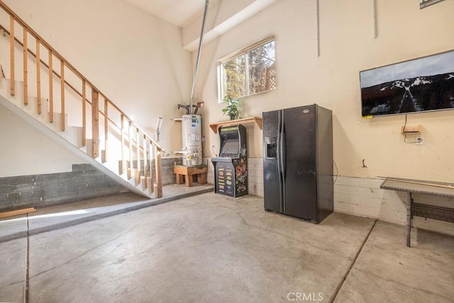 interior space featuring black fridge with ice dispenser and water heater