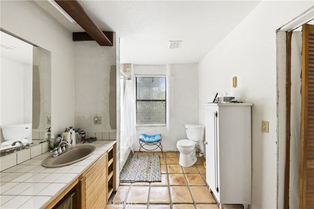 bathroom featuring vanity and toilet