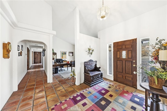 tiled foyer entrance with a towering ceiling