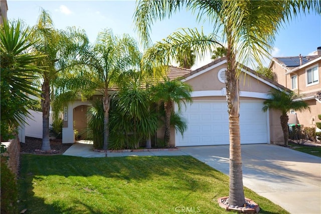 view of front of property with a garage and a front yard