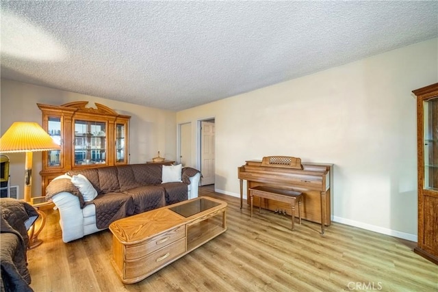 living room with light hardwood / wood-style flooring and a textured ceiling