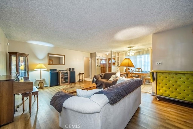 living room with light hardwood / wood-style floors and a textured ceiling