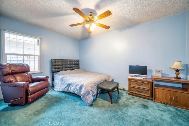 carpeted bedroom with ceiling fan and a textured ceiling