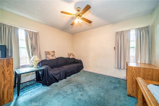 interior space with multiple windows, dark carpet, and a textured ceiling