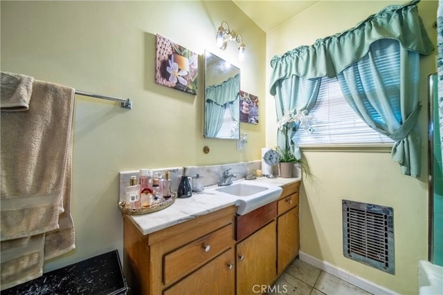 bathroom featuring vanity, tile patterned flooring, and heating unit