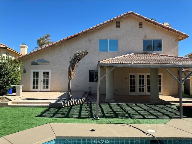 rear view of house with french doors and a patio area