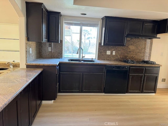 kitchen with sink, decorative backsplash, light hardwood / wood-style floors, and black appliances