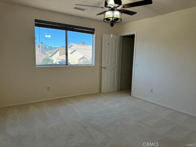 carpeted empty room with ceiling fan