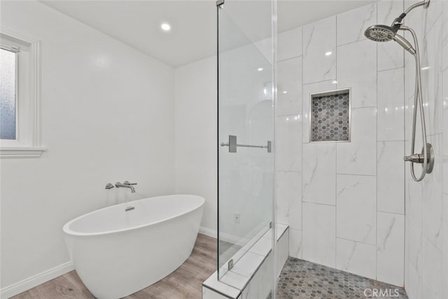 bathroom featuring independent shower and bath and hardwood / wood-style floors